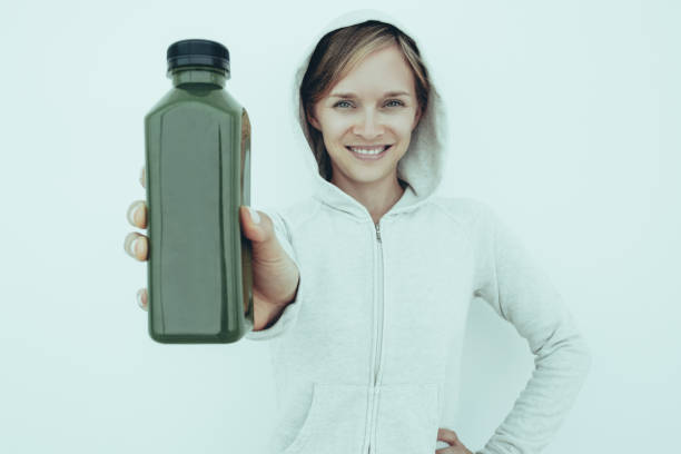 istock Cheerful athletic woman recommending sport drink 997613152