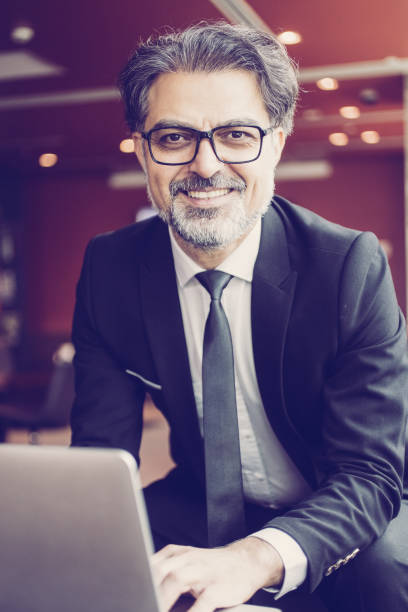 istock Happy Business Man Working on Laptop in Lobby 997616190