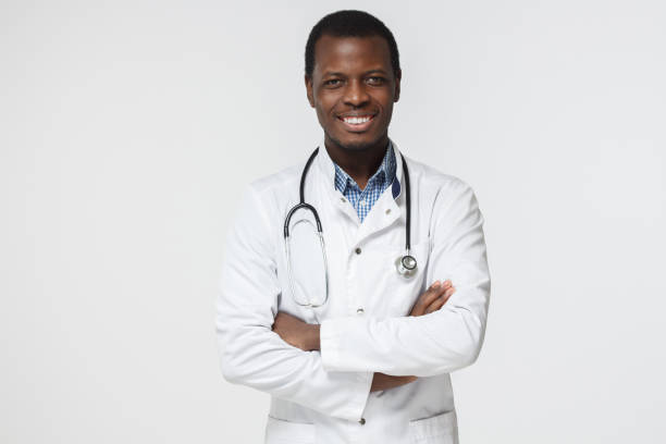 istock Enthusiastic african doctor looking at camera, smiling, standing with crossed arms 997616888