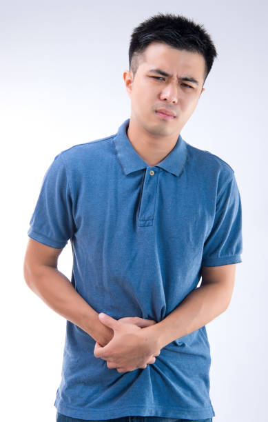 istock Man putting his hands for belly or stomach ache on white background 997626308