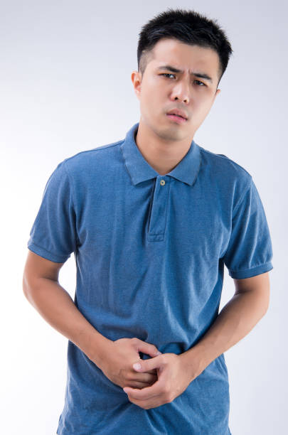 istock Man putting his hands for belly or stomach ache on white background 997626312