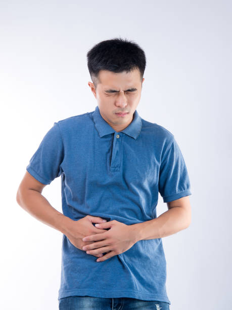 istock Man putting his hands for belly or stomach ache on white background 997626388