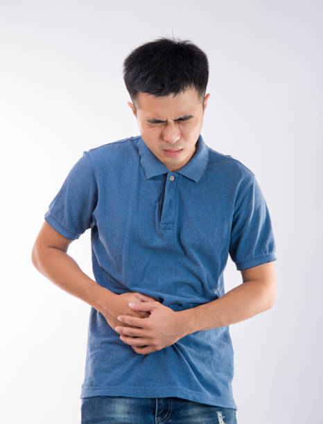 istock Man putting his hands for belly or stomach ache on white background 997626390