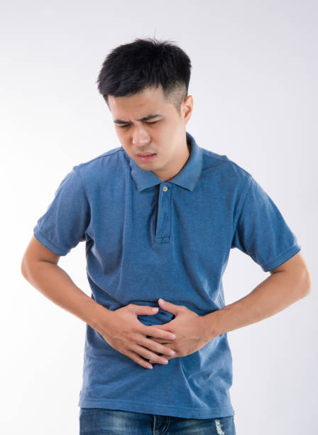 istock Man putting his hands for belly or stomach ache on white background 997626622