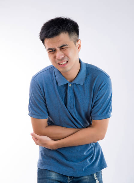 istock Man putting his hands for belly or stomach ache on white background 997626728