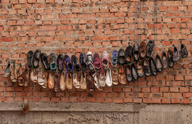 Suspended shoes on a brick wall in the bazaar