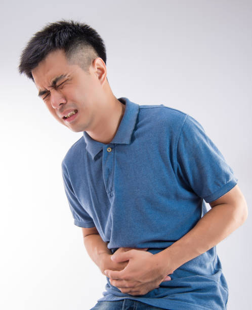 istock Man putting his hands for belly or stomach ache on white background 997626928