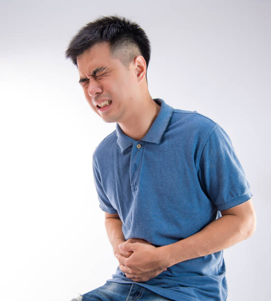 istock Man putting his hands for belly or stomach ache on white background 997627048