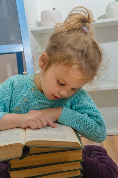 istock child with a book near the chalk Board 997630614