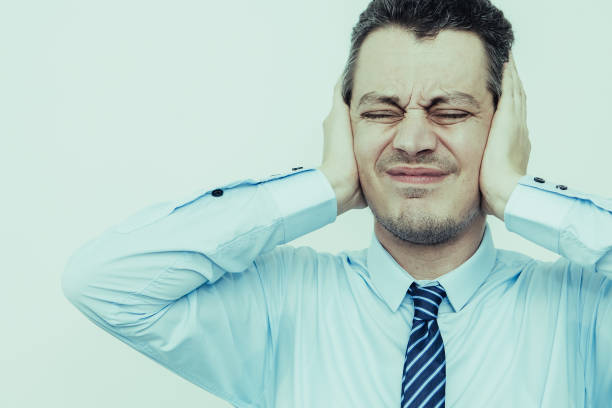istock Tensed Middle-aged Business Man Covering Ears 997632644