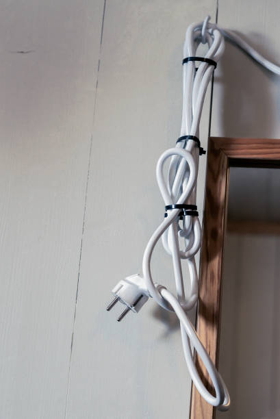 istock A too long powercord hanging on a bathroom wall next to a
mirror 997636452