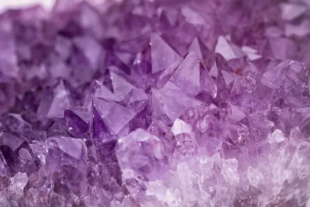 Photo of Close up purple shining amethyst quartz crystal texture abstract background
