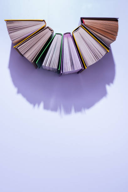 istock top view of stack of books in half circle on violet table 997638520