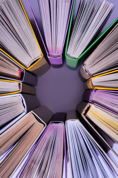 istock top view of stack of colored books in circle on violet table 997638628