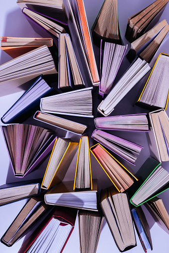 elevated view of scattered stack of books on table