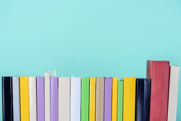 istock row of colored books isolated on blue 997639174