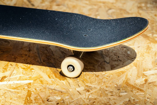 istock skateboard with white wheels on a wooden background in a skatepark 997642732