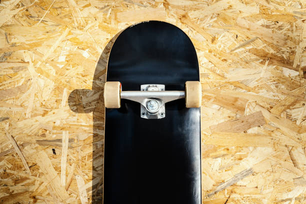 istock skateboard with white wheels on a wooden background in a skatepark 997642864
