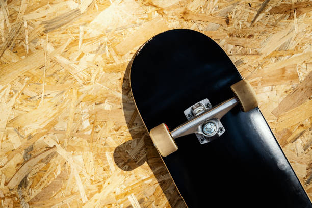 istock skateboard with white wheels on a wooden background in a skatepark 997642880
