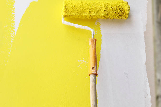 istock Painting with paintbrush yellow and white 997644050