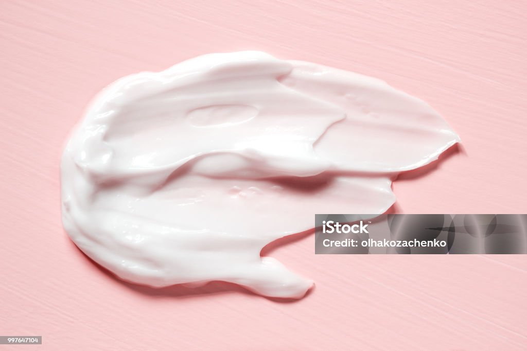 Smear of natural moisturizer in pink background. Cream, Lotion for face or body. Skin care. Moisturizer Stock Photo