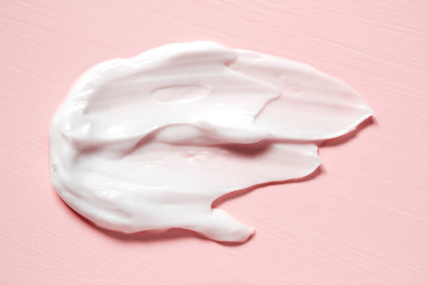 Smear of natural moisturizer in pink background. Cream, Lotion for face or body. Skin care. stock photo