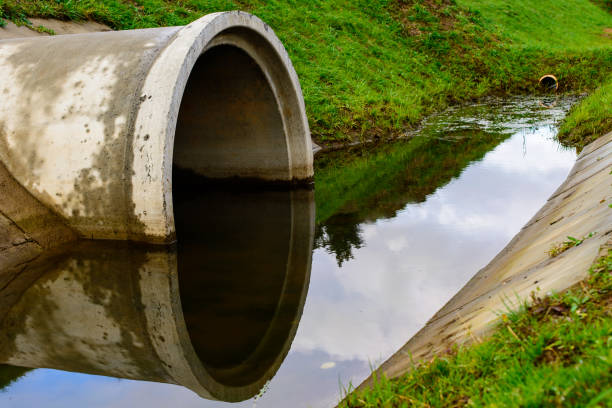 istock Concrete culvert pipe hole system draining sewage water. Environ 997655602