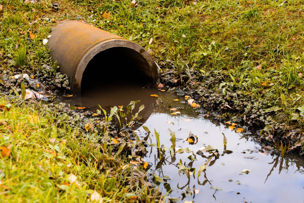 istock Culvert pipe hole system draining sewage water with little puddl 997655932