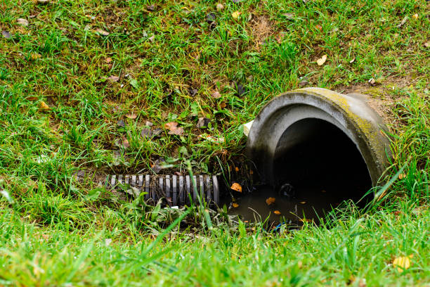 istock Culvert pipe hole system draining sewage water with little puddl 997656028