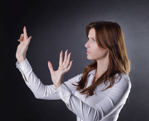 istock uncertain business woman clicks on the virtual button 997661860