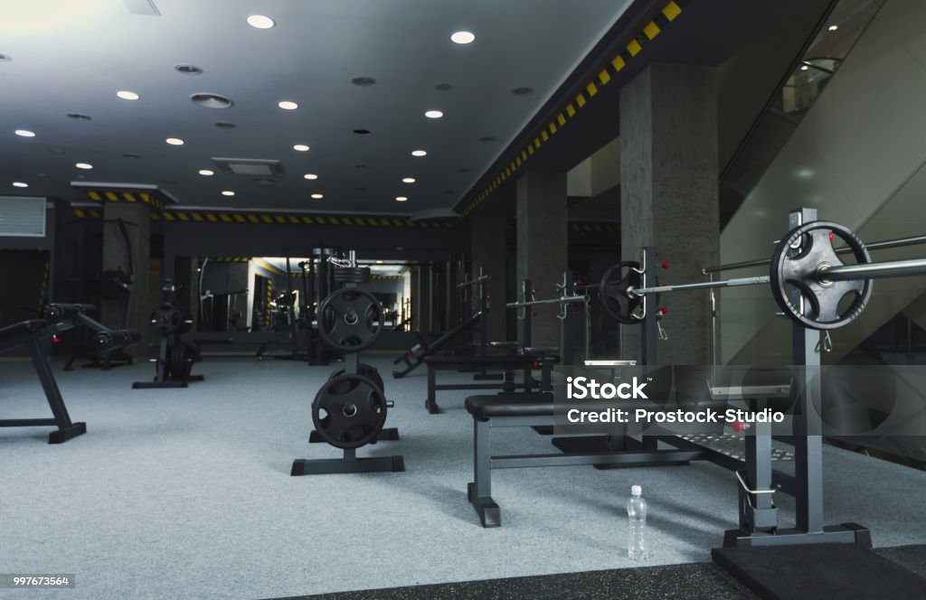 Gym interior with weightlifting equipment Modern gym interior with weightlifting equipment. Fitness background. Healthy lifestyle, bodybuilding concept, copy space Gym Stock Photo