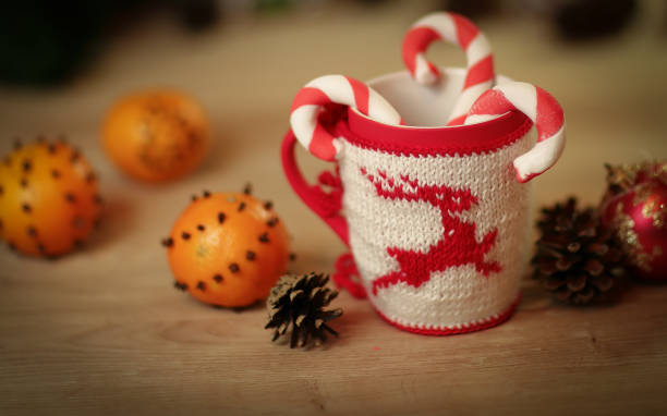 istock Christmas Cup and oranges on wooden background blurred 997674238