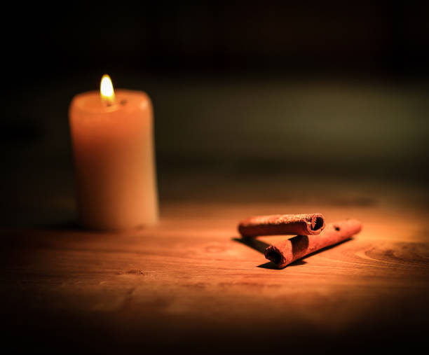 istock Christmas table. candle , oranges and cinnamon sticks on wooden 997677312