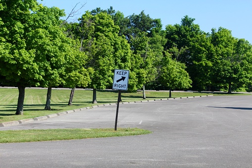 The keep right sign in the parking lot of the park.