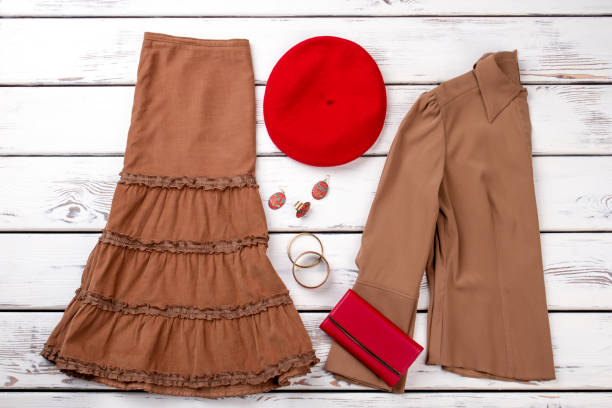 istock Brown clothes, red wallet and berete hat. 997686774