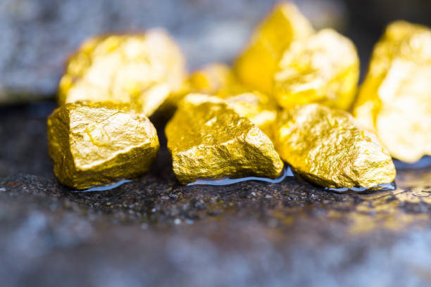 Gold on the stone floor Discovering Success and Investing Concepts with Business Partners. Gold on the stone floor Discovering Success and Investing Concepts with Business Partners. goldco precious metals complaints stock pictures, royalty-free photos & images