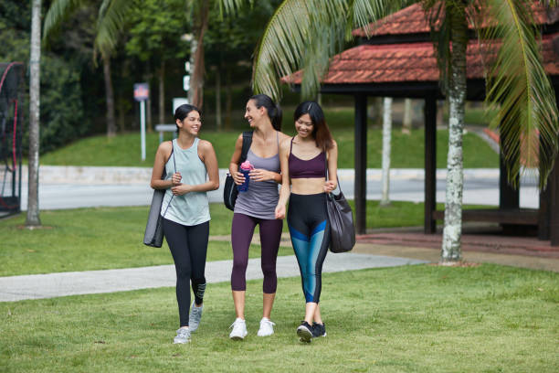 istock Three multi-ethnic friends walking to park for the yoga class 997694874
