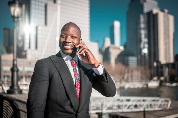 istock Smiling businessman using phone on the go 997695028