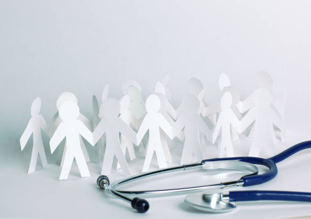 istock stethoscope and paper men on the table 997697994