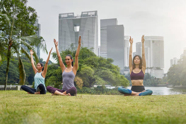 istock Three multi-ethnic women practising yoga outdoors 997699918