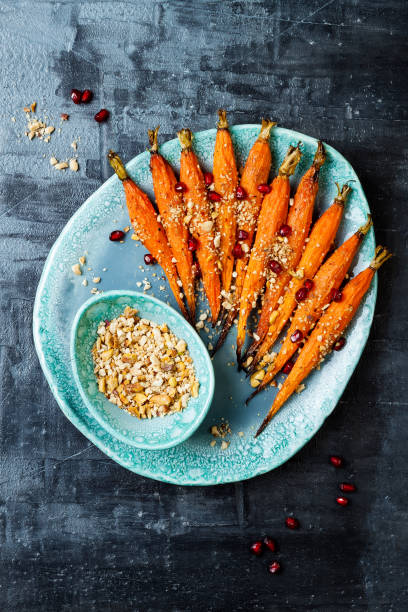 istock Roasted carrots with dukkah. Vegetarian food. Top view, flat lay, copy space 997705436