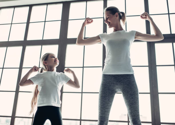 istock Mom with daughter working out at home 997706232