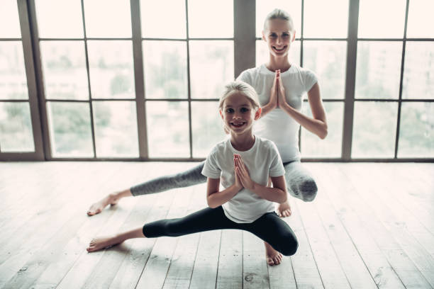 istock Mom with daughter working out at home 997706852