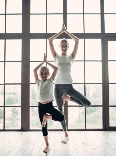 istock Mom with daughter working out at home 997707828