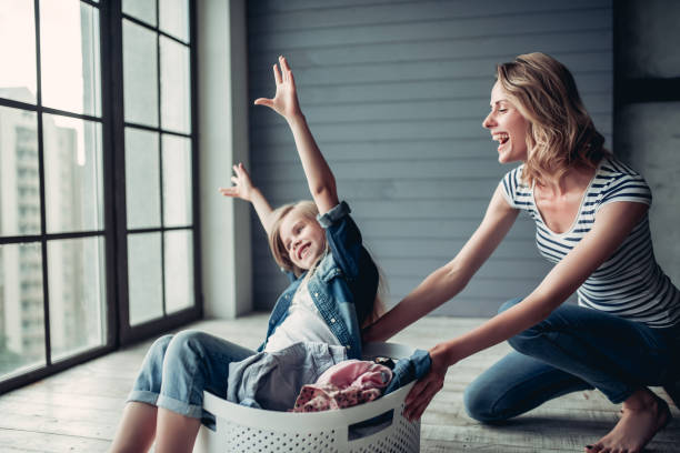 istock Mom with daughter doing cleaning 997708312