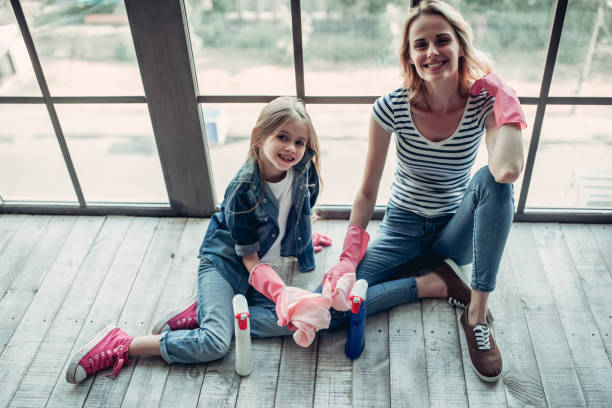 istock Mom with daughter doing cleaning 997708498