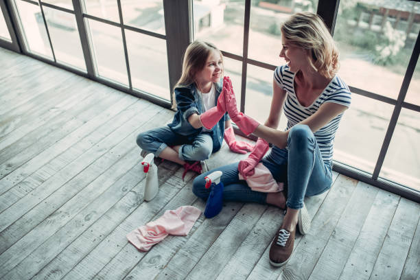 istock Mom with daughter doing cleaning 997708536