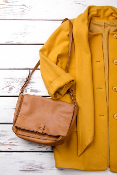 istock Yellow women coat and handbag. 997708692