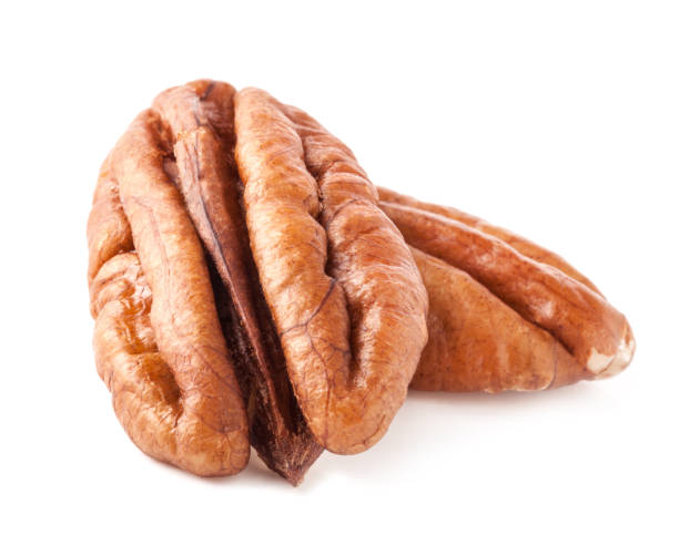 istock Peeled pecan nuts closeup, isolated on white background 997709328