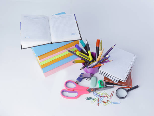 istock open the diary and colourful school supplies on a white background 997709778